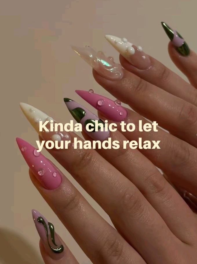 Long stiletto nails in soft pink with pearl and gold accents