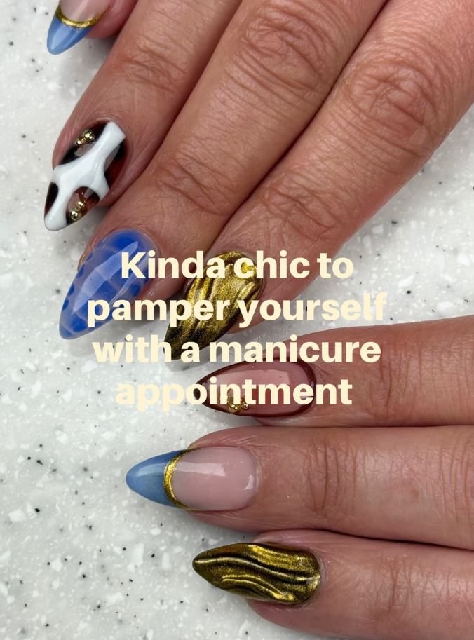 Almond nails in navy and gold chrome with fine line detail