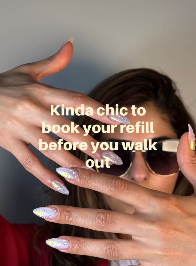 Iridescent glitter nails held up to the light